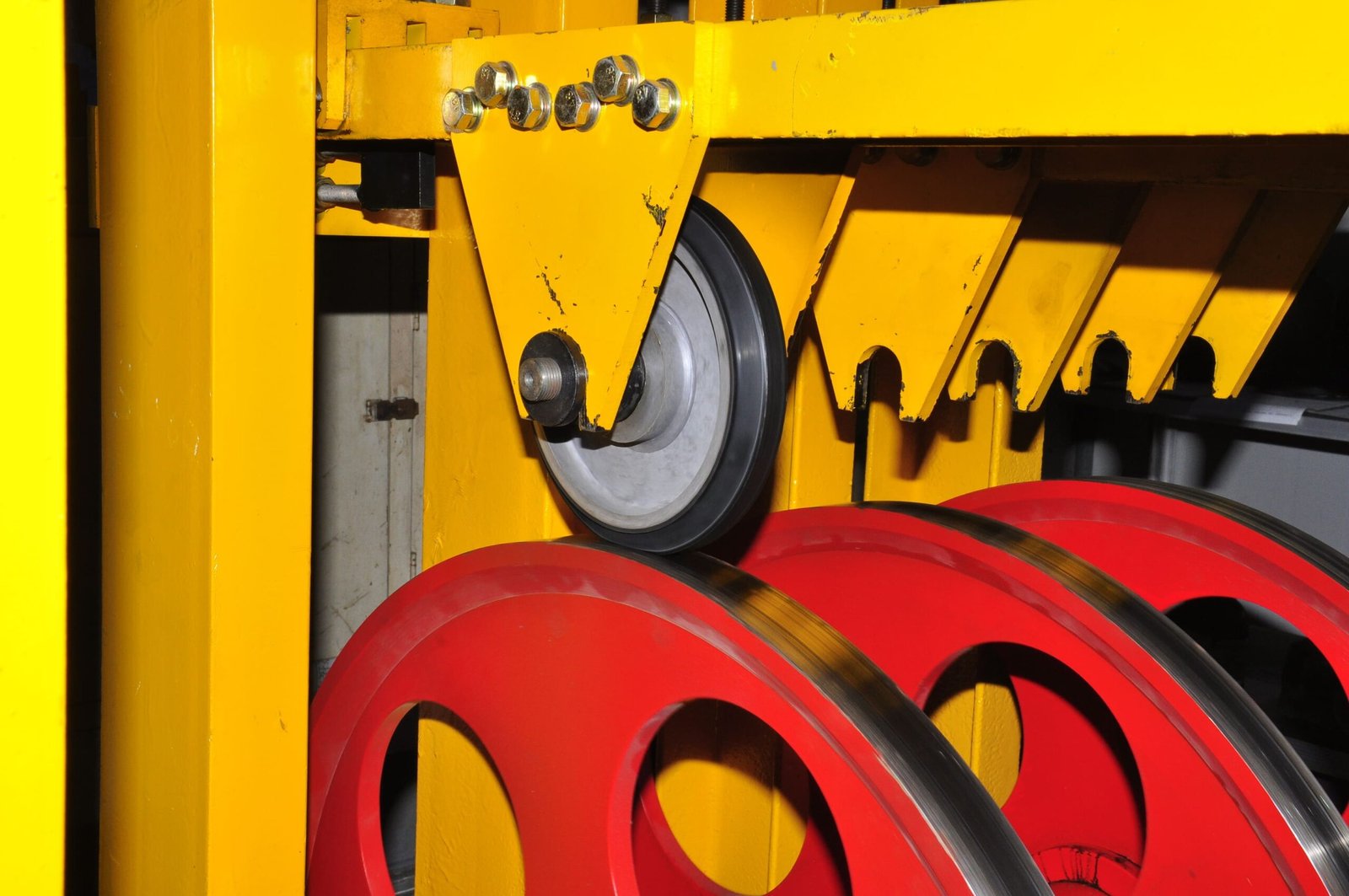 Rubber wheel life test on an industrial test rig, with the rubber wheel running against rotating wheels to evaluate durability and wear