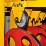 Rubber wheel performance test, black rubber wheel running on steel track, durability testing for industrial applications.