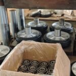 Rubber wheel assembly line, aluminum core wheels with ball bearings, production workshop, precise molding process.