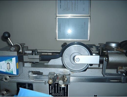 Rubber wheel peel test using a laboratory fixture to evaluate rubber-to-metal bond strength between the tread and wheel hub
